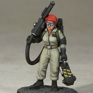 Janey, Paranormal Exterminator by Crooked Dice, one 28mm scale white metal miniature for your RPG or tabletop game representing a female ghost hunter with special equipment for the job.