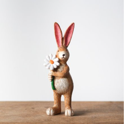 Cute standing rabbit figurine with pointed ears, adorable smile and holding a daisy flower, a sweet and charming edition to your home décor or as a gift.