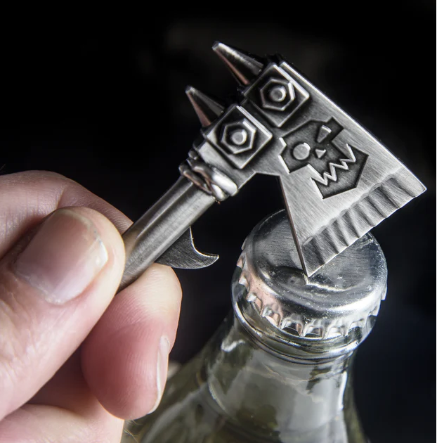 Warhammer 40k Ork Choppa Bottle Opener. Finally you can open your favourite beverage with an Ork axe and who would not want to do that! ok so not an actual Ork axe but certainly a cool, weighty and awesome bottle opener in the style of an Ork axe and I hope you are shouting WAAAGH while you do so.