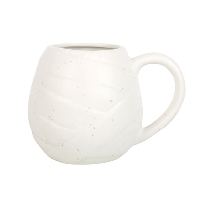 Unwrap the perfect addition to your Halloween homeware with this Mummy Shaped Rounded Mug. With its white speckled design and bandage detail, this rounded mug will keep your favourite drinks under wraps. Plus, those little black eyes add a touch of spooky fun to your kitchenware