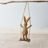 Standing Rabbit On A Swing. An adorable bunny figurine standing on a swing enabling you to hang this cute rabbit in your home, work or window. A quirky animal decoration for yourself or as a gift. 