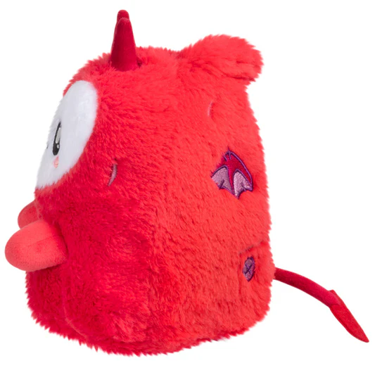 Red plush toy with horns held in...