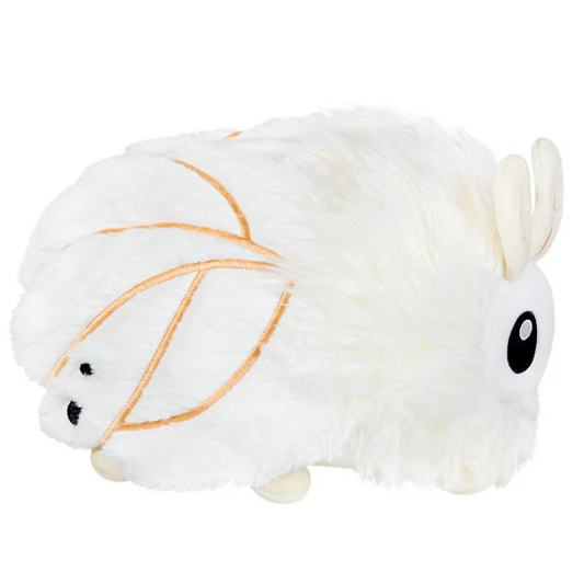 A fluffy white plush toy with la...