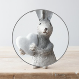 Grey Standing Rabbit With White Heart. A cute bunny figure with one ear folder down, holding a white heart making a wonderful edition to your rabbit ornament collection or as a gift. 