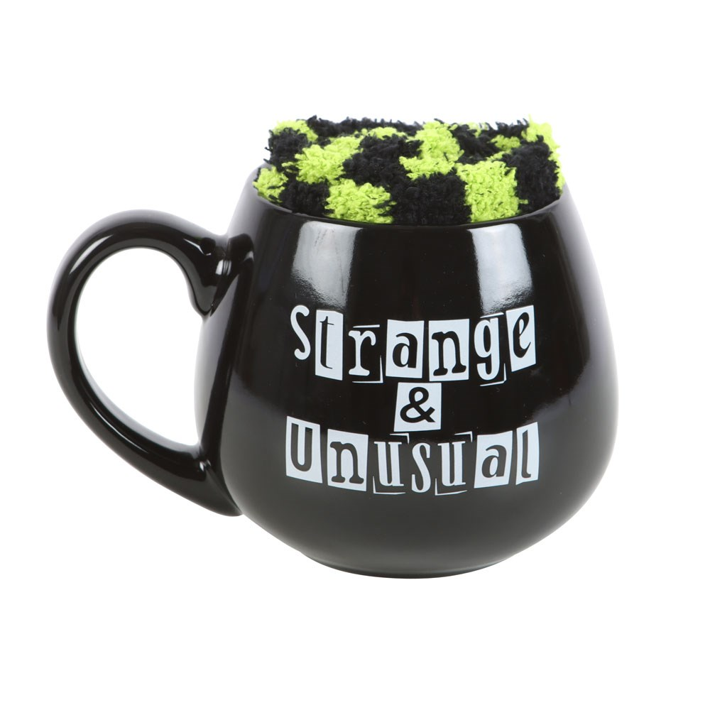 Show your spooky side with this Strange &amp; Unusual mug and Sock Set. The black rounded mug features the phrase Strange &amp; Unusual in striking letters, while the pair of fluffy green and black stripped socks adds a touch of whimsy to your wardrobe. Embrace your gothic style with this unique homeware and accessory set