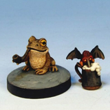 Frog and Stirge Relaxing by Crooked Dice.&nbsp; A pack of two metal miniatures representing a pipe smoking frog and a beer drinking Stirge making a characterful edition to your RPG and tabletop games.