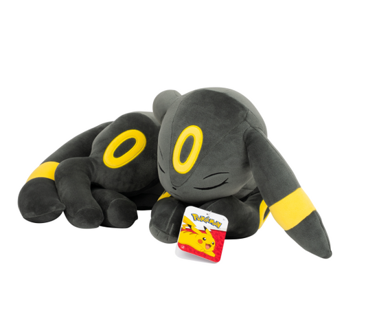 A sleeping Eevee plush toy in bl...