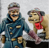 Road Agents 2 by Crooked Dice.  A set of two metal figures representing an evil racing driver and his pet dog both wearing racing goggles on their heads for your table top gaming needs.