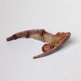 A wrecked rowboat from Iron Gate Scenery by Stone Axe Minis in 28mm scale printed in abs like resin and provided unpainted for your tabletop games and hobby needs.