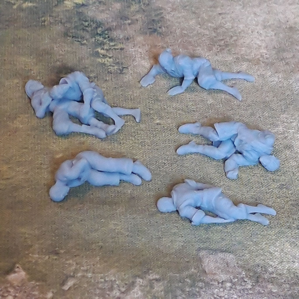 Dead Men by Iron Gate Scenery printed in resin for 28mm scale with four single dead men and one with two dead men together to help you decorate your tabletop games, RPGs, wargames and other hobby needs.