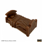 A miniature brown plastic bed fr...