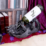 Dragon Guzzler Wine Bottle Holder by Nemesis Now. A dragon laid on its back holding a bottle in its back and front legs with the neck of the bottle in its mouth 