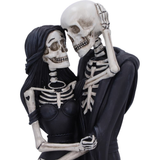 Eternal Embrace figurine by Nemesis Now - Two skeletons holding each other, the male wearing a long cape and the female in a black dress with her hand on the others head
