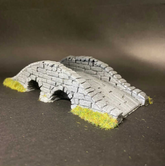 A miniature grey stone arch brid...