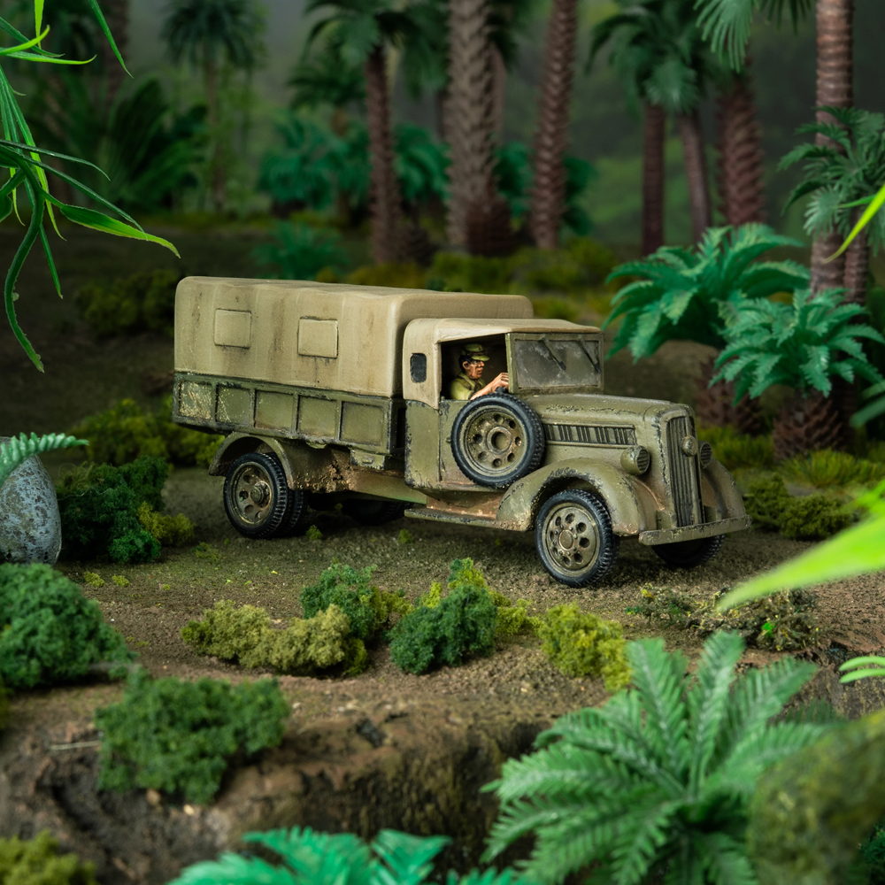 Model of an old military truck in a jungle setting. Bolt Action Type 97 Isuzu Truck 1/56 Resin Model – Warlord Games