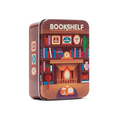 A square metal tin box for a game called BOOKSHELF, featuring a colorful illustration of a cozy bookshelf with a fireplace, books, and a sleeping fox on the front, shown on a plain white background. Bookshelf - Tinned Building Game