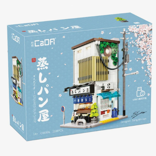 CaDA Japanese Steamed Bun Shop 1108-piece building set with LED lighting, open-back design, and detailed Japanese street food shop interior.