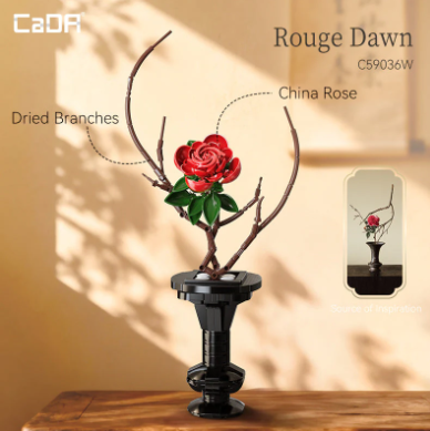 A decorative dried branch arrangement with a single red China rose and green leaves in a black pedestal vase, shown on a wooden surface against a warm beige wall with shadow patterns. Text labels identify the product as 'Rouge Dawn' and 'Dried Branches / China Rose,' with a small inset showing the arrangement from a different angle. CaDA Rouge Dawn Artizan Eastern Floral Art