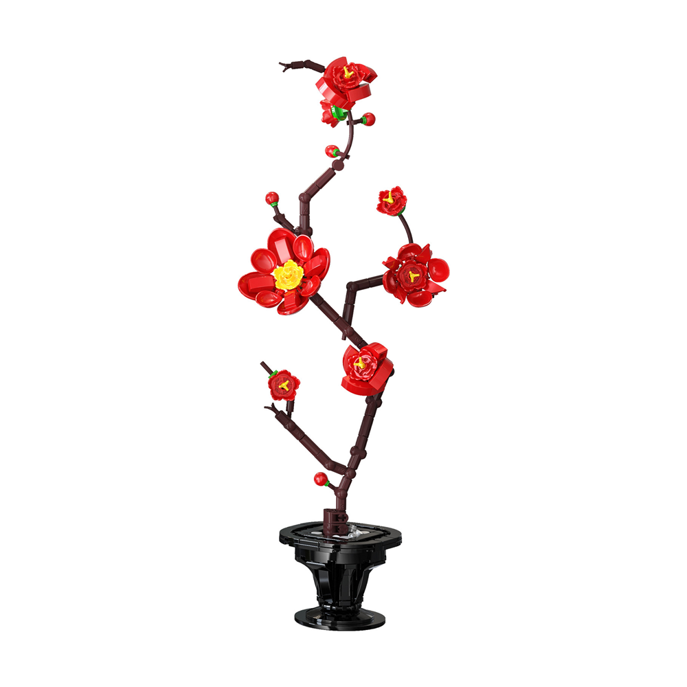 A decorative artificial plum blossom branch arrangement with bright red flowers, yellow centres, and dark brown branches mounted on a black pedestal base, shown against a plain white background. CaDA Silk Blossom Artizan Eastern Floral Art  Building Brick Kit