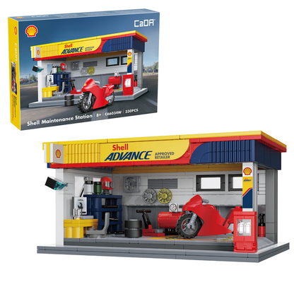 Shell-themed toy maintenance station with a motorcycle and various tools, featuring CaDA branding. CaDA Shell Maintenance Service Station Brick Model Kit