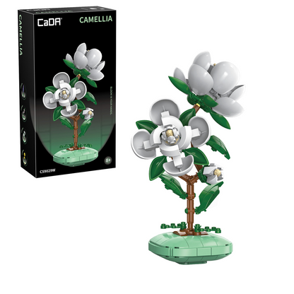 CaDa camellia Model of a camellia flower made from interlocking bricks next to its packaging