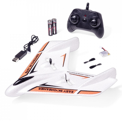 Carson Easy Skydreamer orange. RC airplane with remote control, batteries, and USB cable on a white background