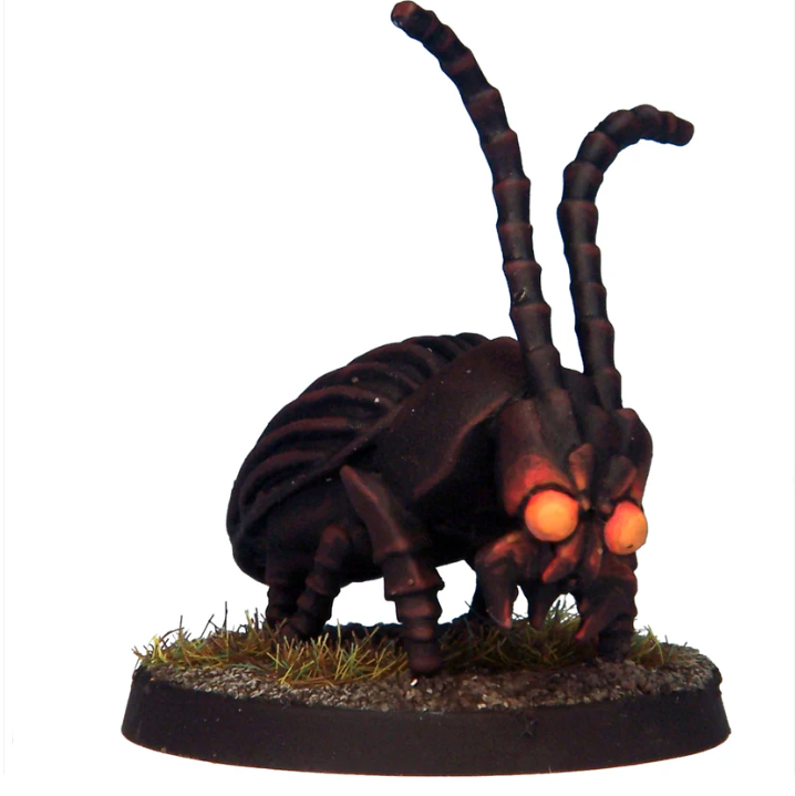 Miniature insect figure with glowing eyes on a white background. Crooked Dice Giant Beetle white metal fantasy creature miniature with 30mm round base unpainted
