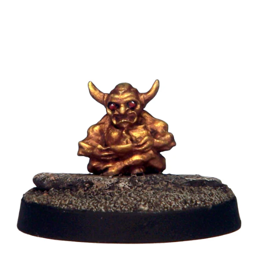 Small golden figurine on a dark base against a white background. Crooked Dice Otherworld Demon Idol white metal objective token miniature with 20mm slotta base unpainted