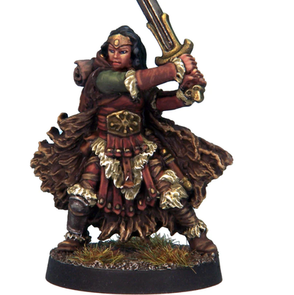 Female barbarian miniature holding a sword high with both hands, wearing warm clothing and belt. White metal model for tabletop RPGs and painting.