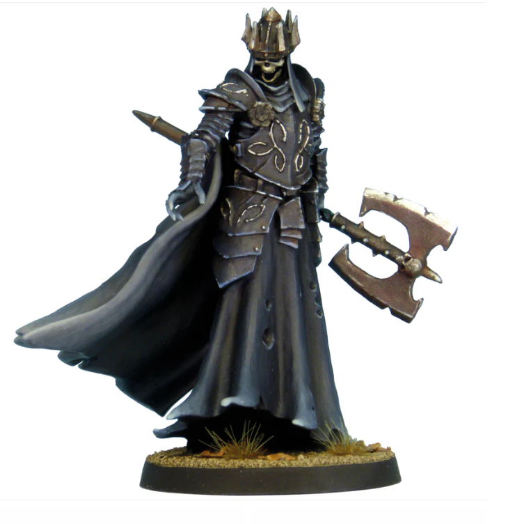 An undead skeletal creature holding a large axe, outstretched hand downwards, wearing a crown, armour, billowing cloak, and long skirt, cast in resin.