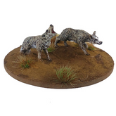 Two wolf figurines on a round ba...