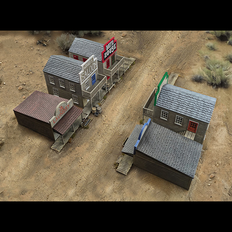 Model of a western town with buildings and signs on a desert landscape. Dead Man’s Hand Two-Horse Town