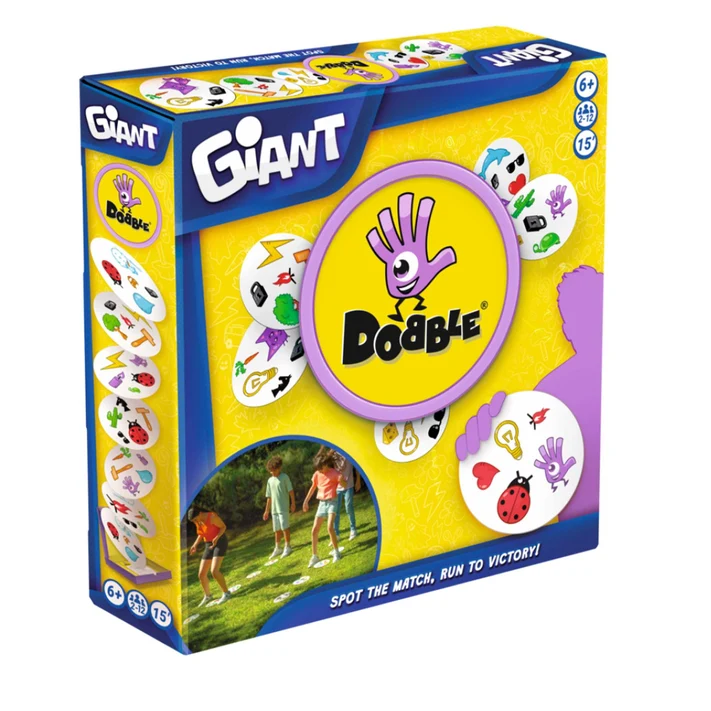 Giant Dobble game box shown at a three-quarter angle on a plain white background. The packaging is bright yellow and blue with a large purple Dobble logo and illustrations of matching game pieces. Dobble Giant - Indoor & Outdoor Play