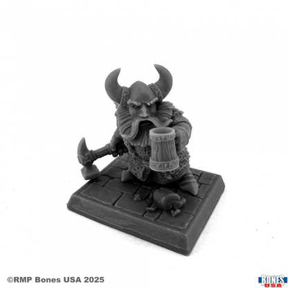 Dwarven Hero (30216). A bold Bones USA miniature featuring a dwarf warrior with an axe and tankard, standing on a textured base. Multipart, unpainted.

