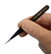 Hand holding a pair of tweezers ...