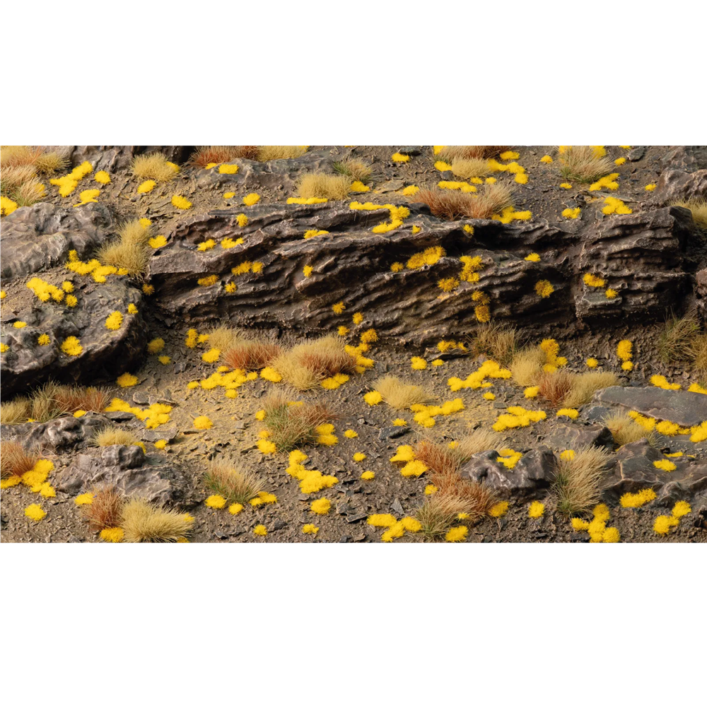 Gamers Grass Tiny Golden 1mm self-adhesive grass tufts sheet for miniature basing. Yellow flowers on a rocky terrain