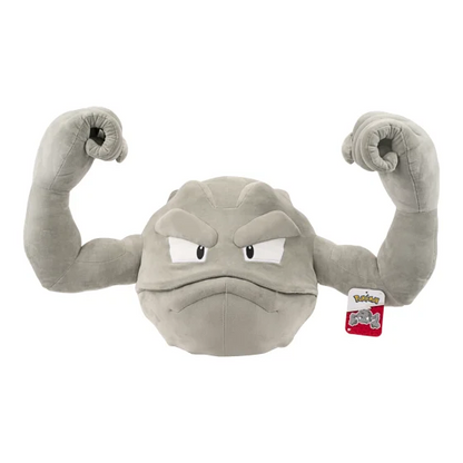 A gray plush toy resembling a muscular, angry stone-like character with raised fists, shown on a plain white background. A small Pokémon tag is attached near the right side. Geodude 24" Pokémon Plushie