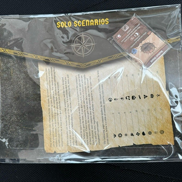 Game scenario book with 'Solo Scenarios' label inside a clear plastic bag.
