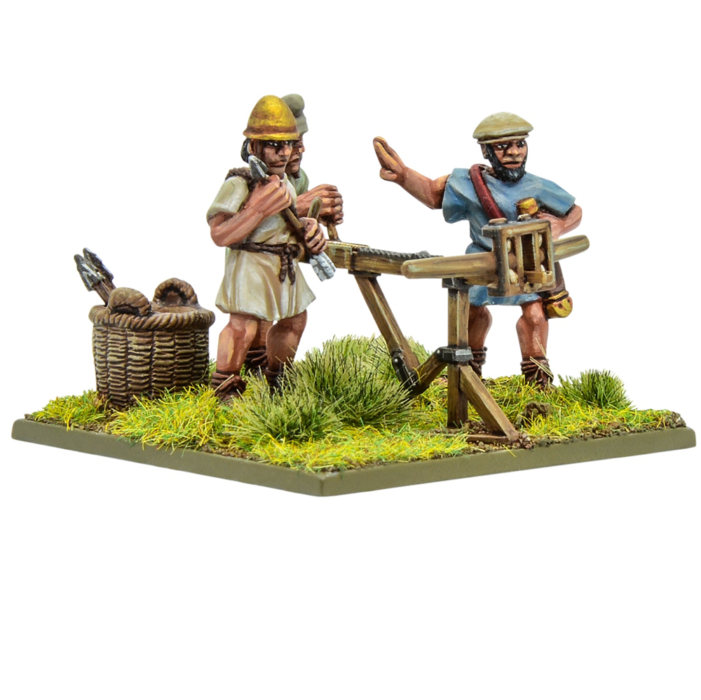 Warlord Games Hail Caesar Hellenistic Greek light artillery bolt thrower 28mm metal miniature with crew. Two miniature figures of Roman soldiers with a crossbow stand on a grassy base.