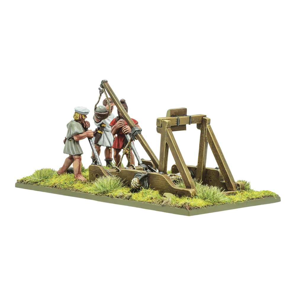 Warlord Games Hail Caesar Hellenistic Onager with crew 28mm metal siege engine miniature. Model of people operating a medieval trebuchet on a grassy platform with a white background