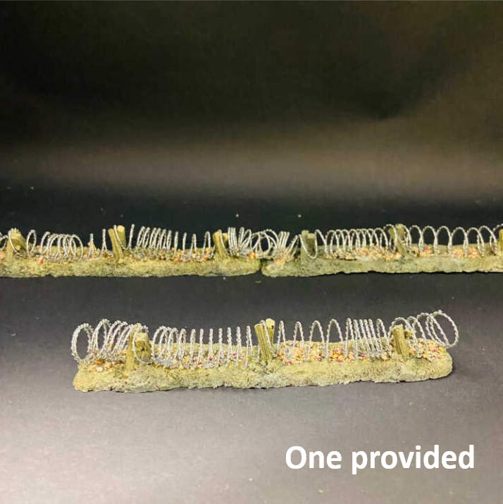 Two miniature wire fence sections with green-tinted bases, shown on a dark background with the text 'One provided' in the lower right corner. Javis Linked Barbed Wire Barrier Resin Tabletop Terrain