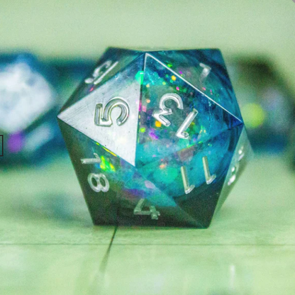 Multicolored polyhedral dice with numbers on a green surface