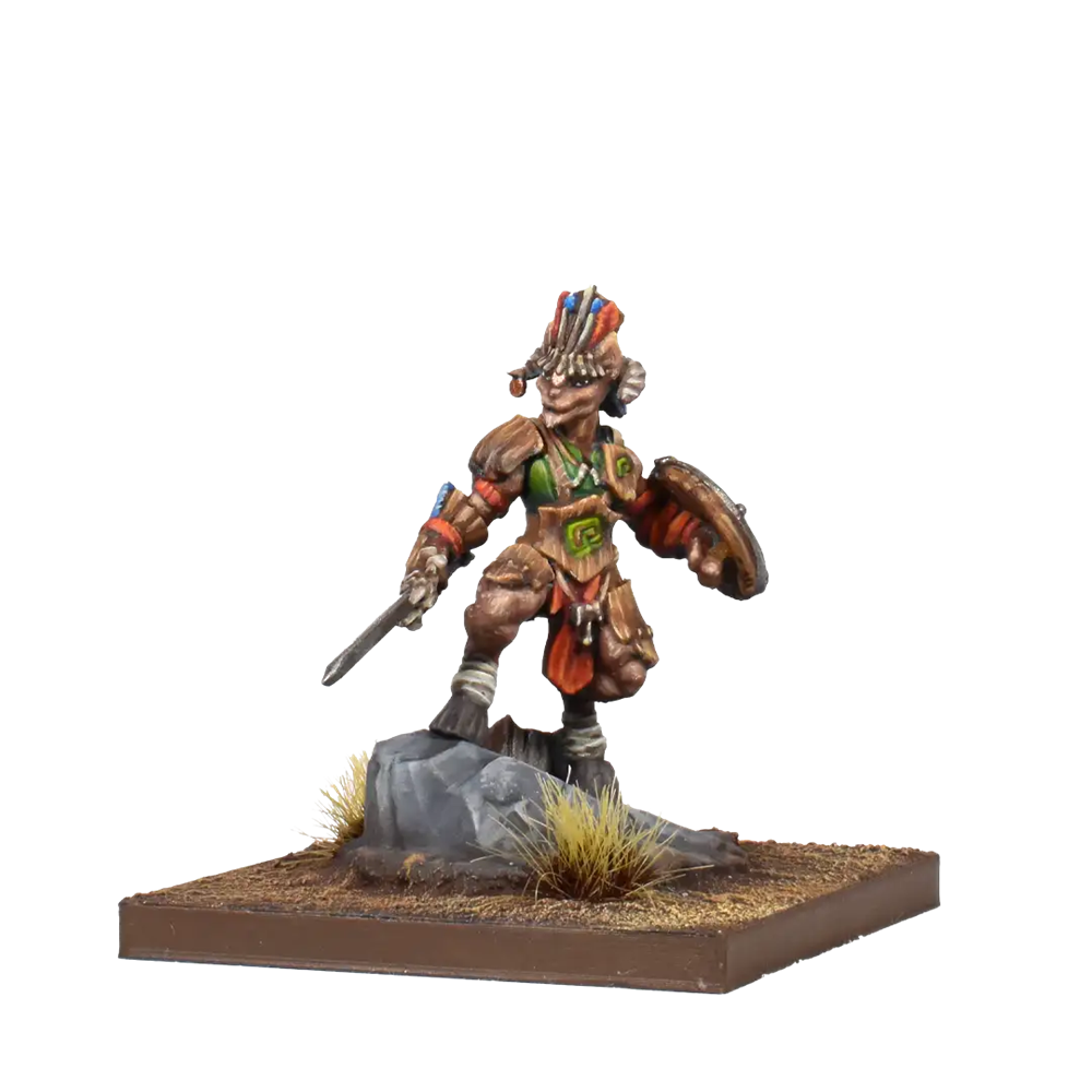 A painted fantasy tabletop miniature figurine of a warrior standing on a rocky base with grass, holding a sword and shield, photographed against a plain white background. Kings of War Forces of Nature Tribal Chieftain resin miniature