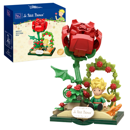 Toy set from 'Le Petit Prince' with red rose and character figure, including packaging.