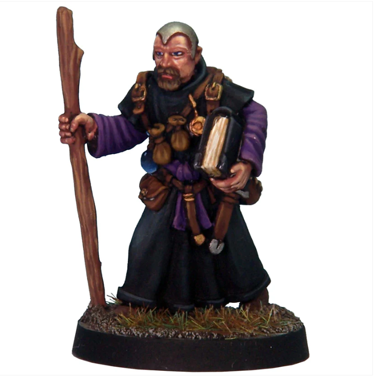 Magic User With Skullcap. White metal miniature of a wizard in skullcap holding a staff and large book, with pouches and items on belt, supplied unpainted for tabletop gaming.