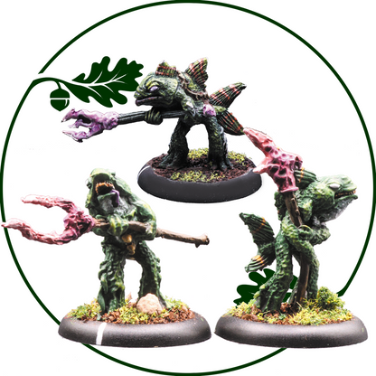 Three painted fantasy monster fish miniatures on round bases, arranged inside a circular frame with a green oak-leaf motif on a white background. Merfolk Spearfish by Oakbound Studio