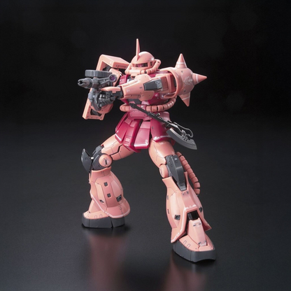 A pink and red mecha action figure posed dynamically with a black weapon, set against a dark black background. Ms-06s Zaku II