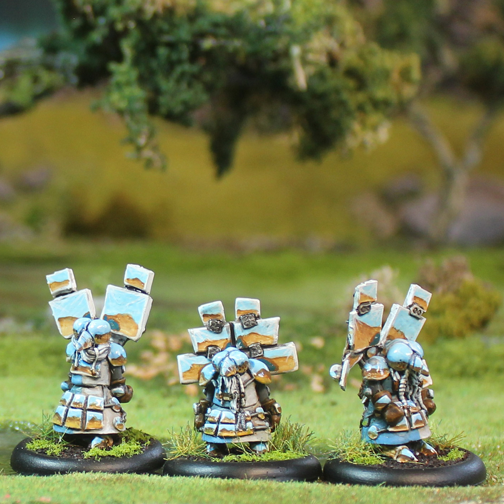 Oakbound Studio Baitit Lightbringers. Three miniature figures in a forest setting