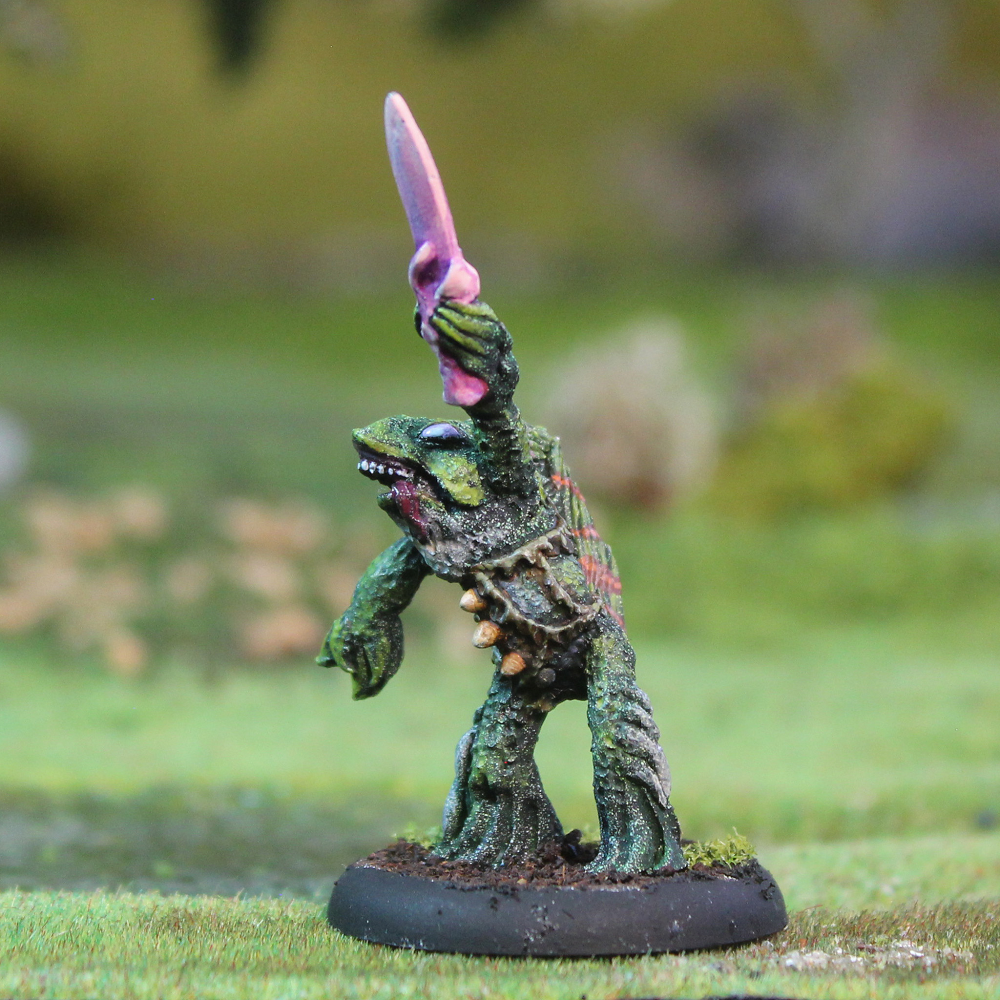 28mm Bucca Priest miniature by Oakbound Studio. Fish-like cultist with dagger raised high, lead pewter unpainted model for fantasy wargames or RPGs