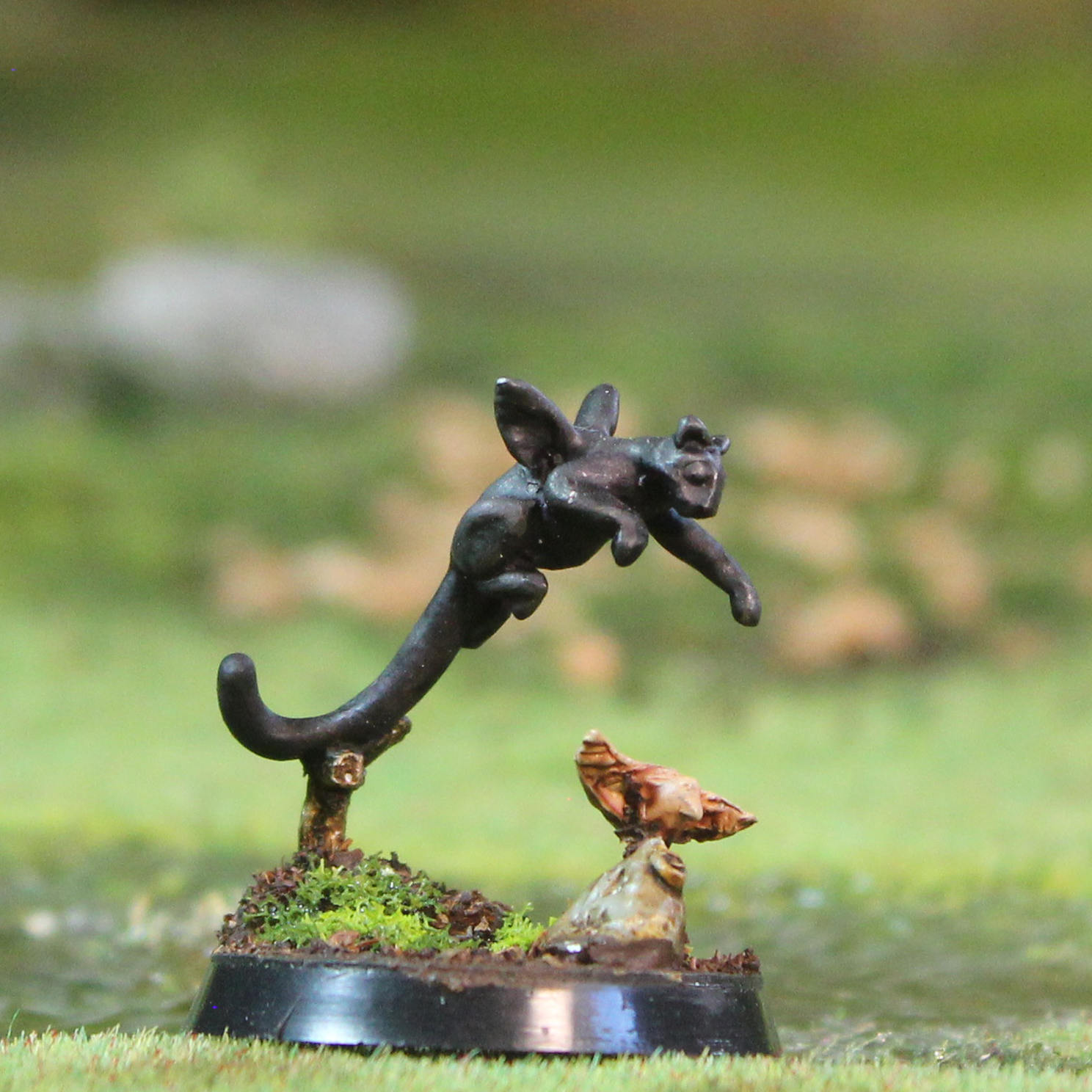 Oakbound Studio Cuhuihui. Miniature figurine of a fairy on a branch with a blurred natural background